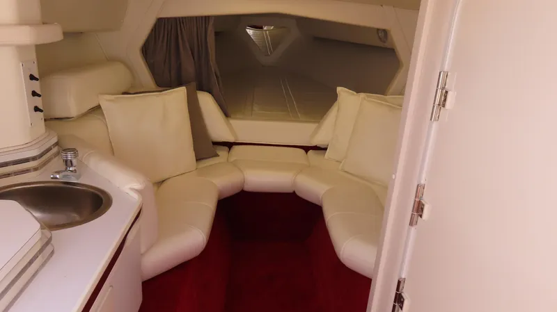 Slide: The Image of Interior of 2004 Fountain 35 Executioner boat with white seating and compact sink. - 18