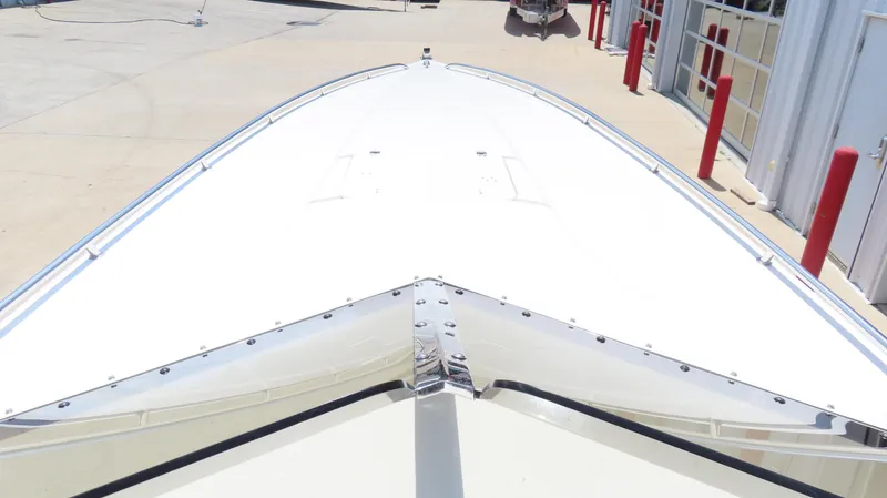 Slide: The Image of 2004 Fountain 35 Executioner boat bow, sleek design, parked in a marina. - 19