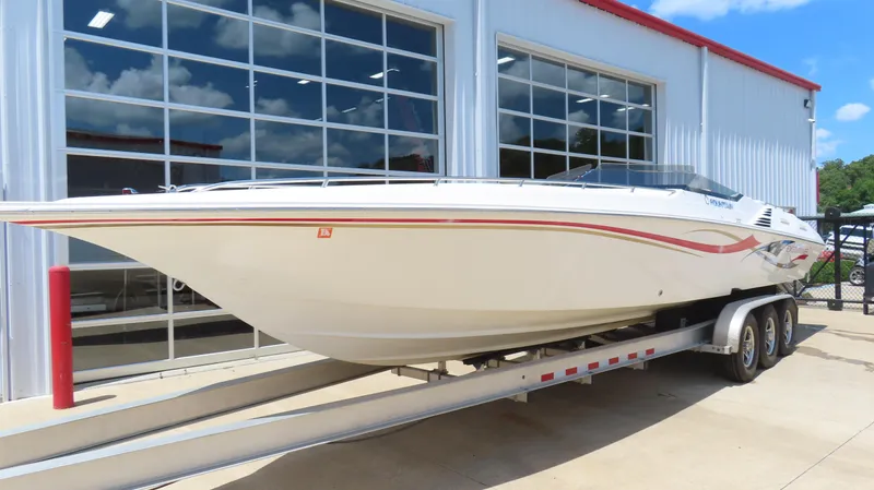 Slide: The Image of 2004 Fountain 35 Executioner speedboat on trailer outside a modern garage. - 2