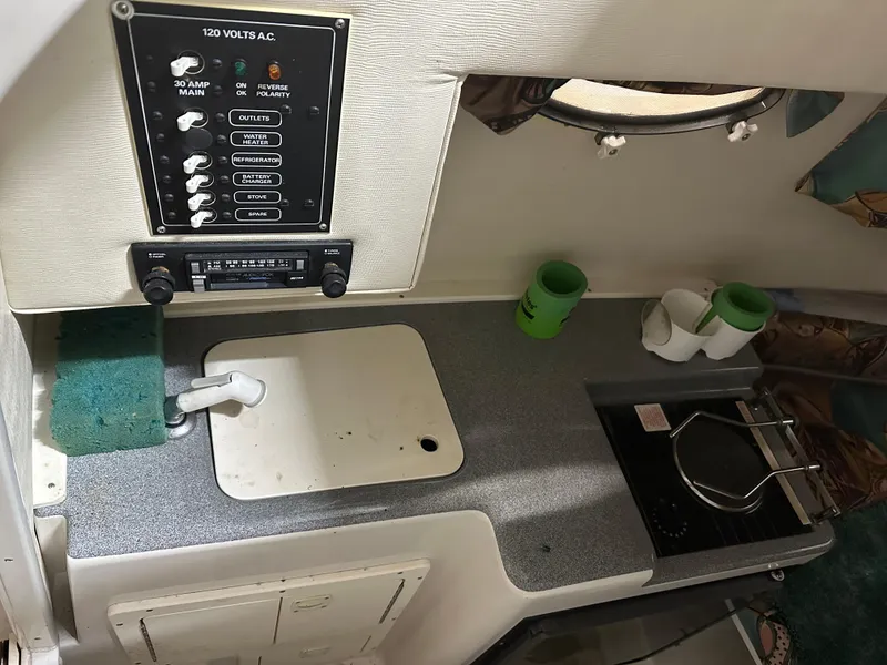 Slide: The Image of 1996 Pro-Line 251 Walkaround I/O cabin interior with control panel and kitchenette. - 17