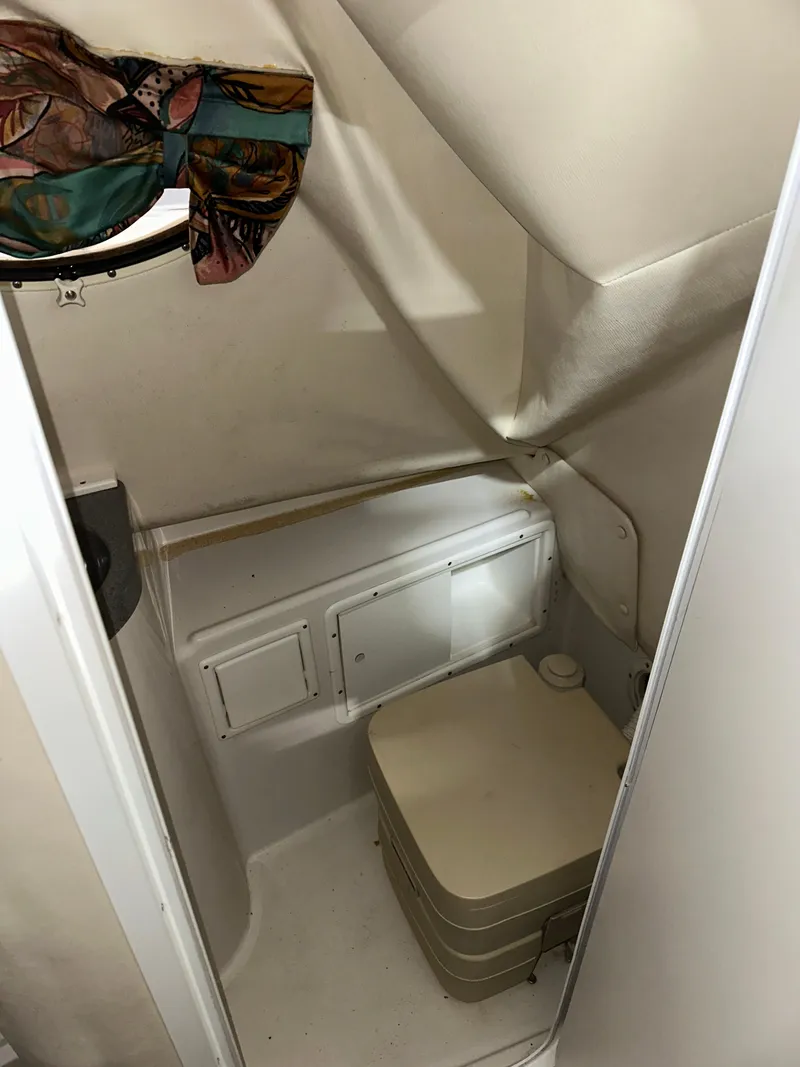 Slide: The Image of Interior of 1996 Pro-Line 251 Walkaround I/O boat with compact bathroom area. - 18