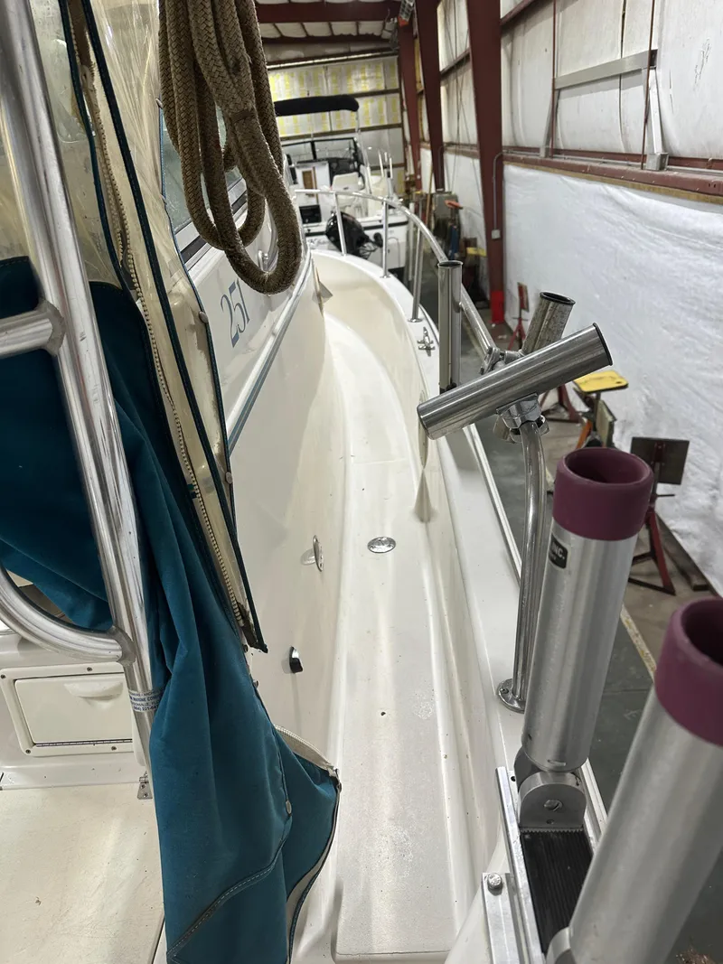 Slide: The Image of 1996 Pro-Line 251 Walkaround I/O boat in storage, featuring deck and railing details. - 6