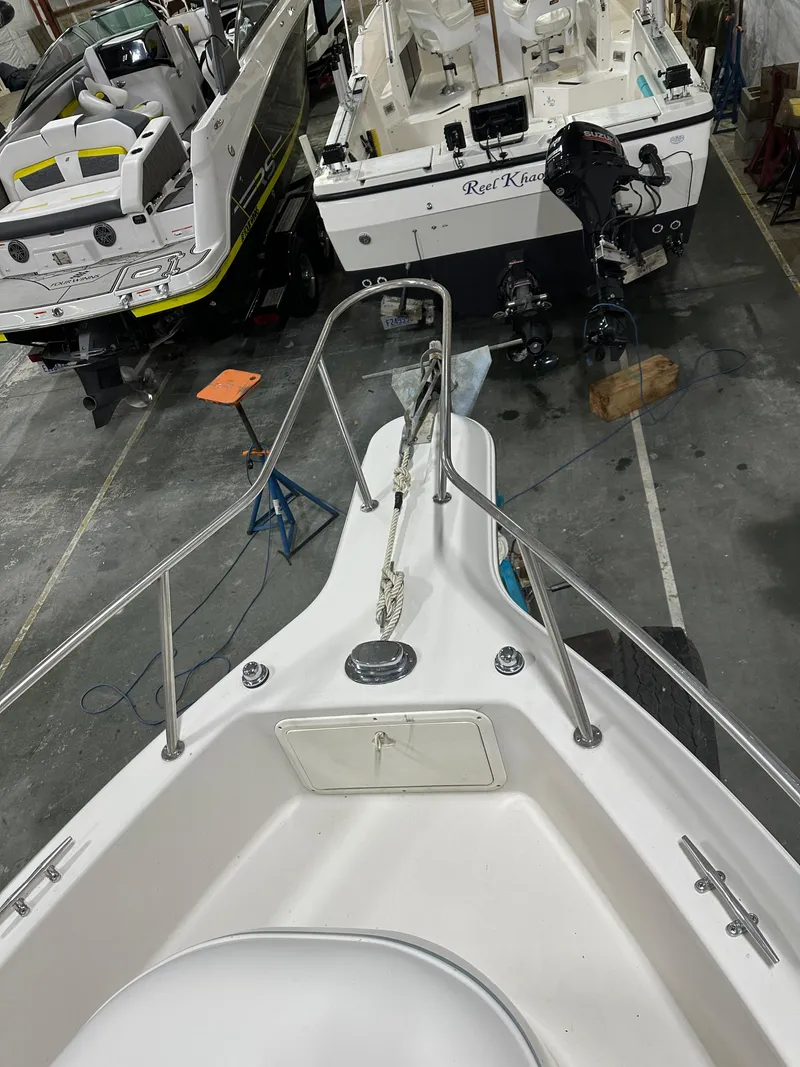 Slide: The Image of 1996 Pro-Line 251 Walkaround I/O boat in a storage facility, viewed from the bow. - 8