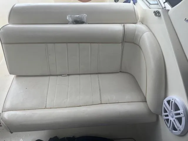 Slide: The Image of White leather seating on a 1997 Monterey 296 Cruiser boat interior. - 10