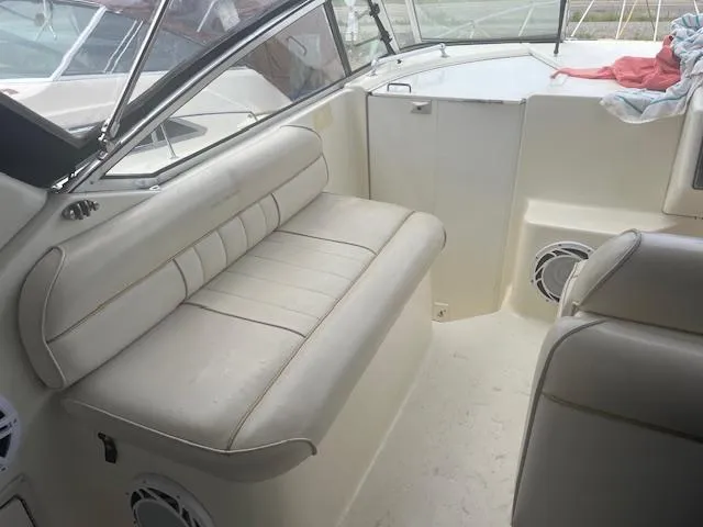 Slide: The Image of 1997 Monterey 296 Cruiser interior with white seating and speakers. - 11