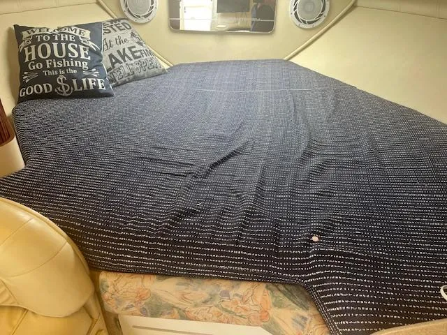 Slide: The Image of Cozy cabin interior of 1997 Monterey 296 Cruiser with nautical-themed pillows and bedding. - 14
