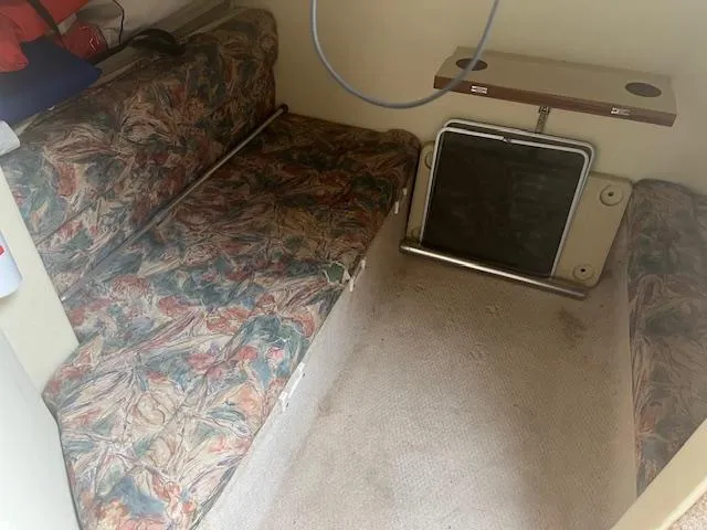 Slide: The Image of Interior of 1997 Monterey 296 Cruiser with patterned seating and small table. - 16