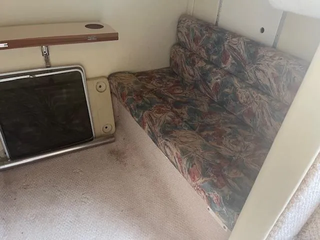 Slide: The Image of Interior of 1997 Monterey 296 Cruiser with floral-patterned seating and compact table. - 17