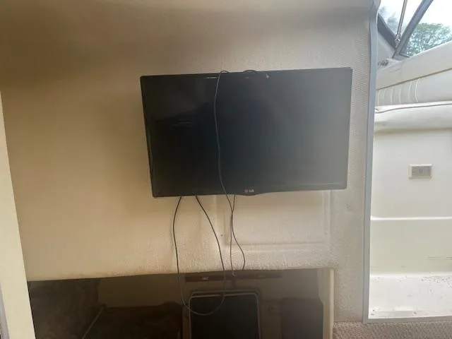 Slide: The Image of Interior of 1997 Monterey 296 Cruiser with wall-mounted TV and visible wiring. - 18