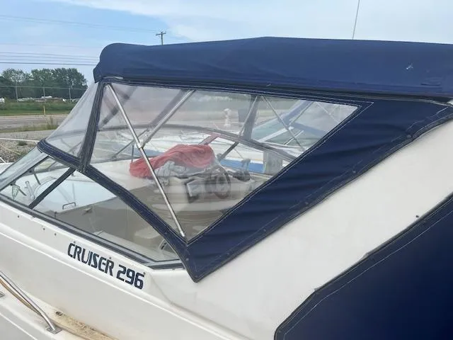 Slide: The Image of 1997 Monterey 296 Cruiser with blue canopy, docked outdoors. - 5