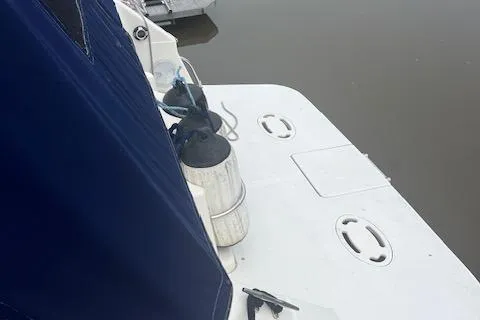 Slide: The Image of 1997 Monterey 296 Cruiser boat deck with blue cover and docked fenders. - 6