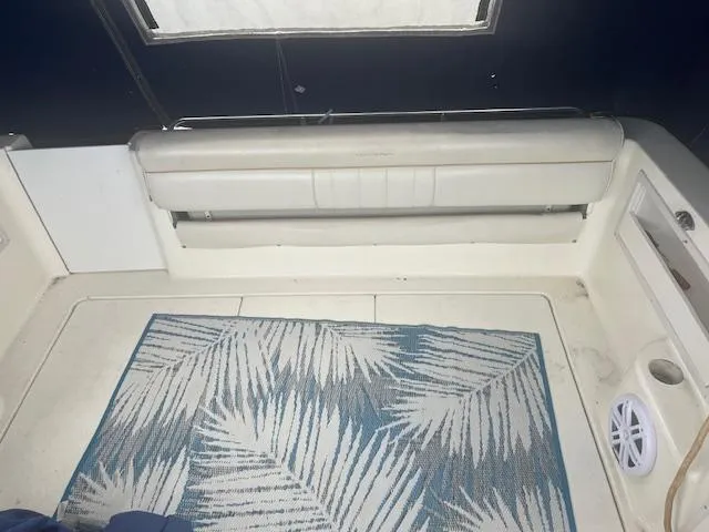 Slide: The Image of Interior of 1997 Monterey 296 Cruiser with white seating and patterned rug. - 9