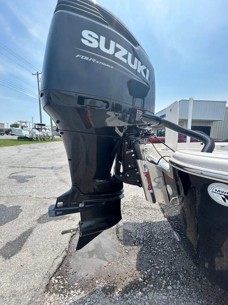 Slide: The Image of Outboard motor on a 2025 Sea Chaser 26 LX boat, featuring Suzuki four-stroke engine. - 11