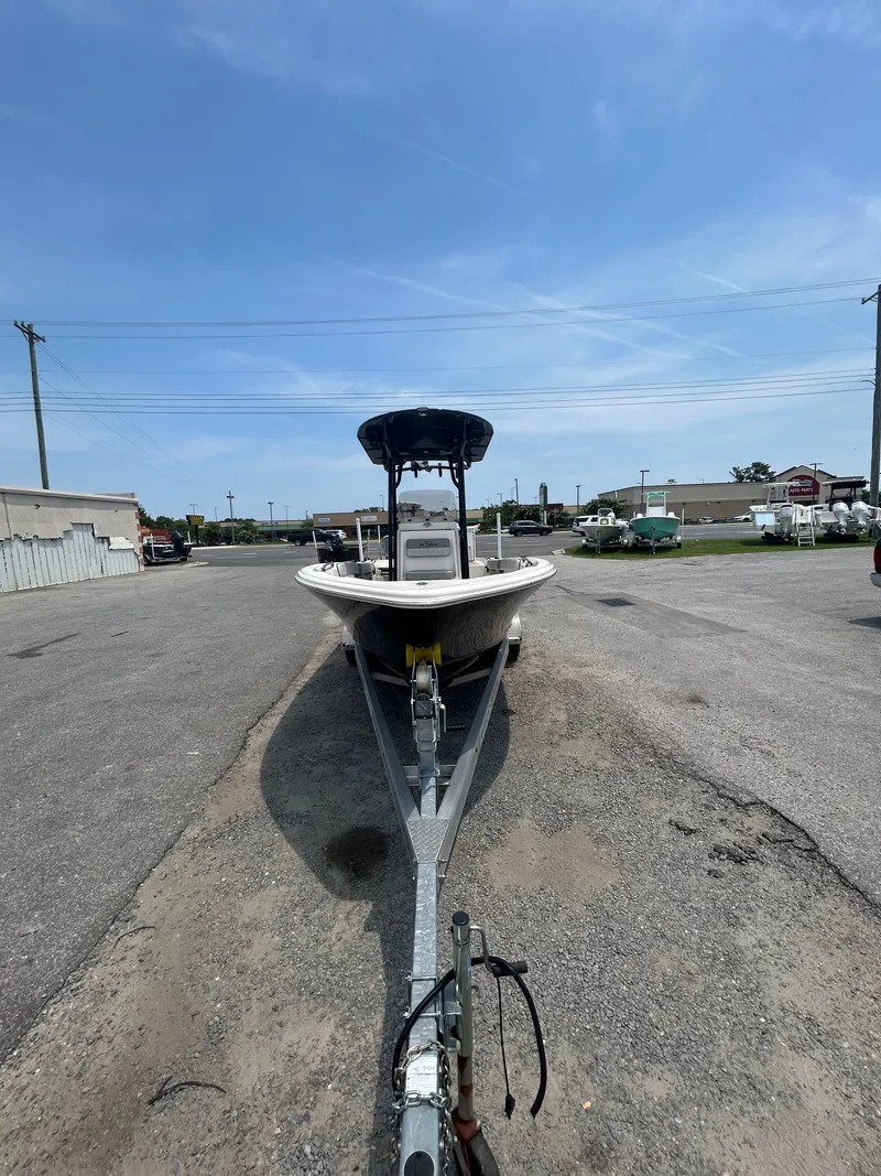 Slide: The Image of 2025 Sea Chaser 26 LX boat on trailer in parking lot under clear sky. - 13