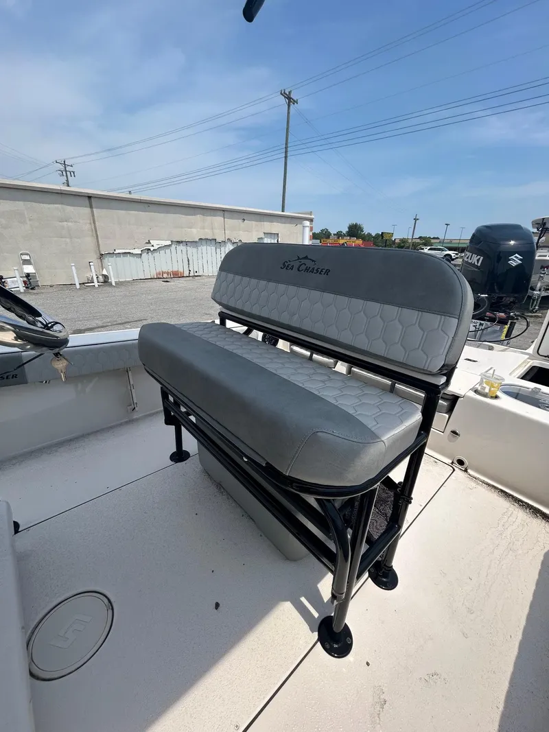 Slide: The Image of 2025 Sea Chaser 26 LX boat interior with gray seating and Suzuki engine. - 7