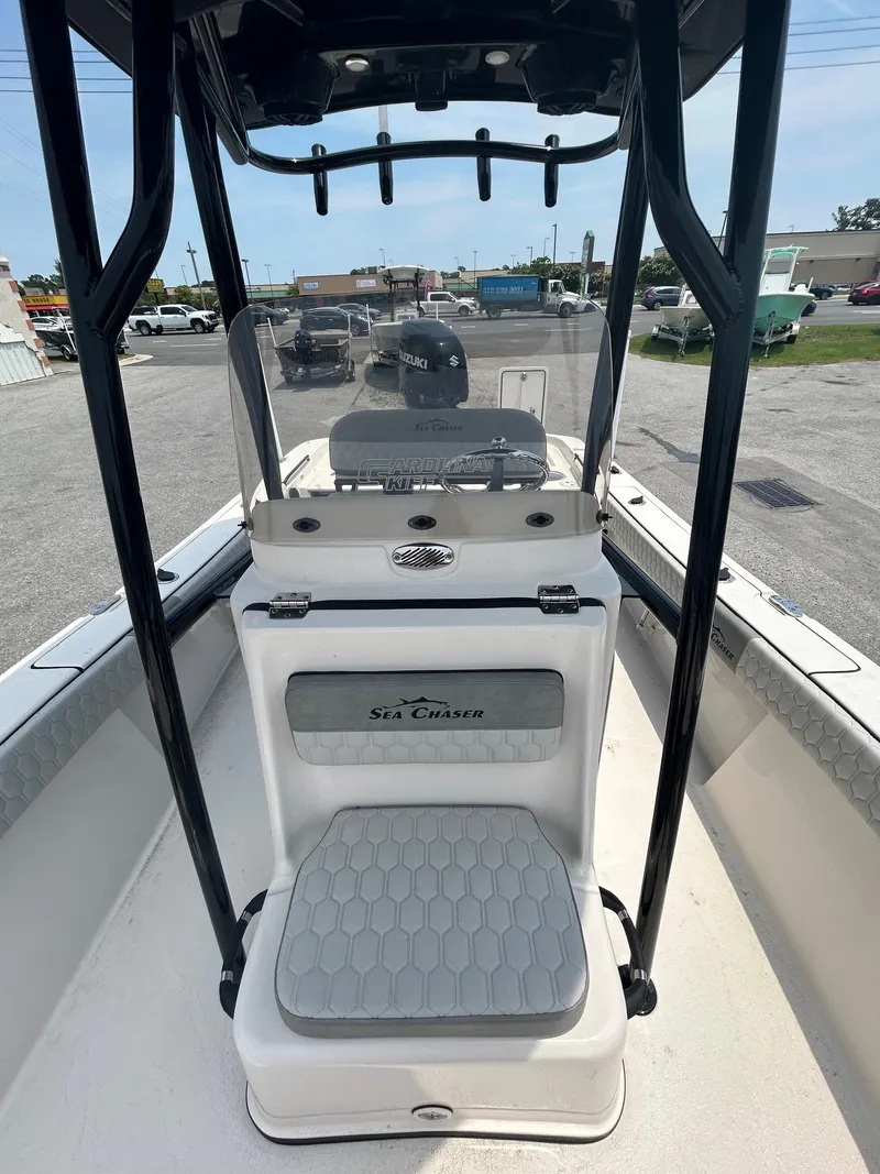 Slide: The Image of 2025 Sea Chaser 26 LX boat interior with seating and console view. - 9