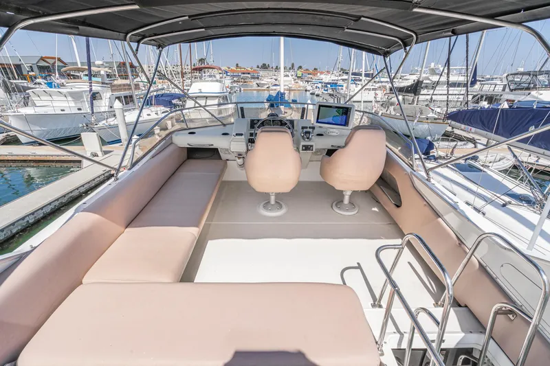 Slide: The Image of Flybridge of 1992 Bayliner 4388 yacht with seating and helm, docked in marina. - 12