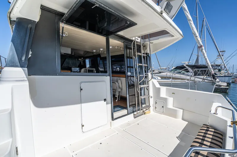 Slide: The Image of 1992 Bayliner 4388 yacht with open deck and marina view. - 18