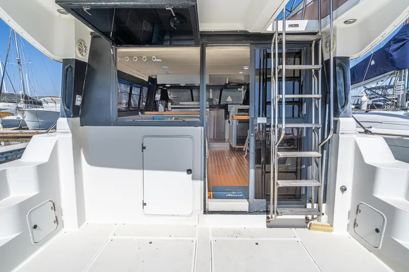 Slide: The Image of 1992 Bayliner 4388 yacht interior with open deck, ladder, and marina view. - 21