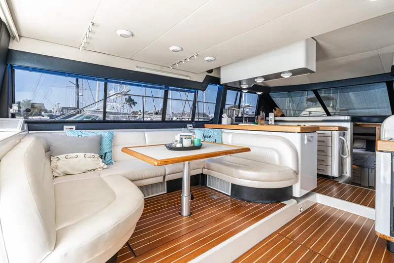Slide: The Image of Luxurious interior of a 1992 Bayliner 4388 yacht with elegant seating and wooden flooring. - 27