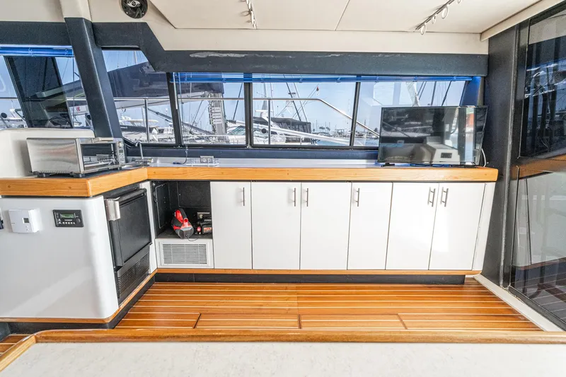 Slide: The Image of Interior of 1992 Bayliner 4388 yacht with modern kitchen and wooden flooring. - 28