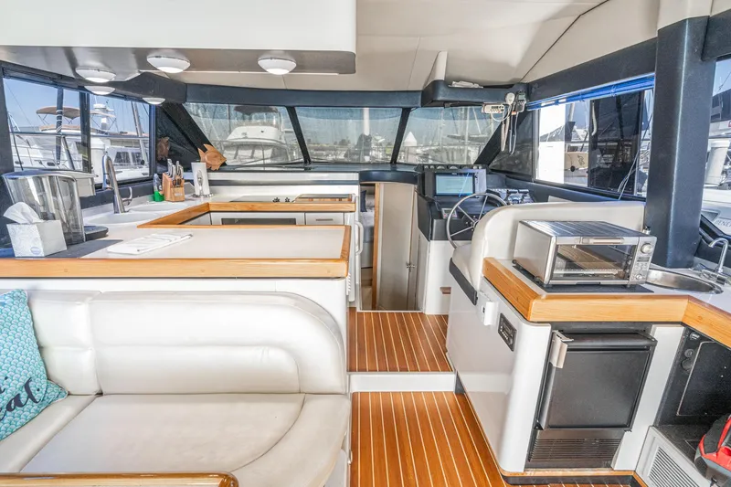 Slide: The Image of Interior of 1992 Bayliner 4388 yacht with modern kitchen and seating area. - 29