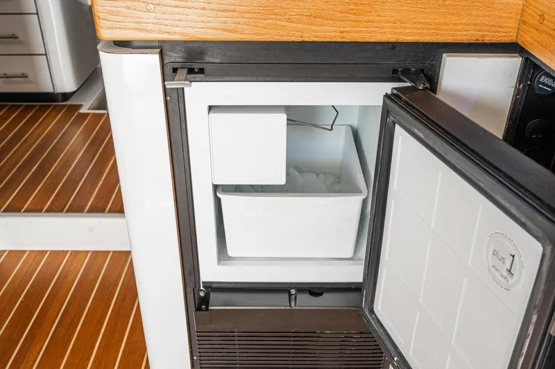 Slide: The Image of Ice maker inside 1992 Bayliner 4388 yacht, with wooden flooring and open door. - 30