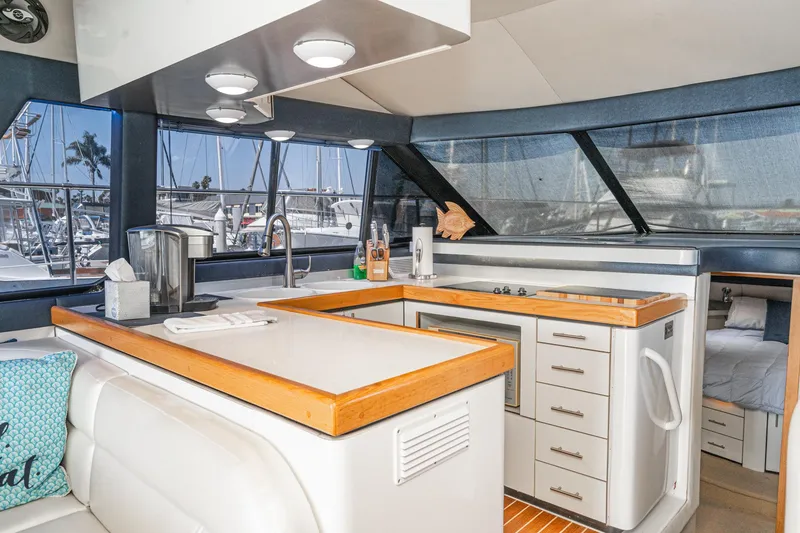 Slide: The Image of Interior of 1992 Bayliner 4388 yacht with modern kitchen and marina view. - 32
