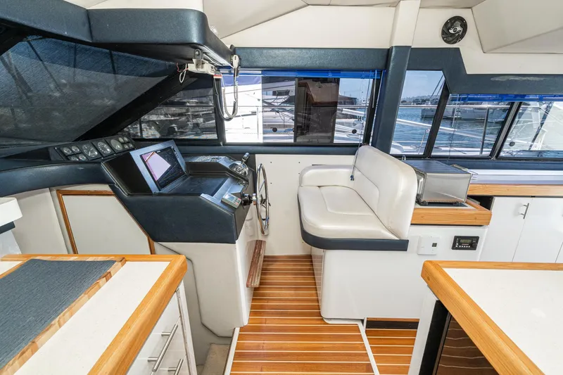 Slide: The Image of Interior of 1992 Bayliner 4388 yacht with helm, seating, and wood accents. - 37