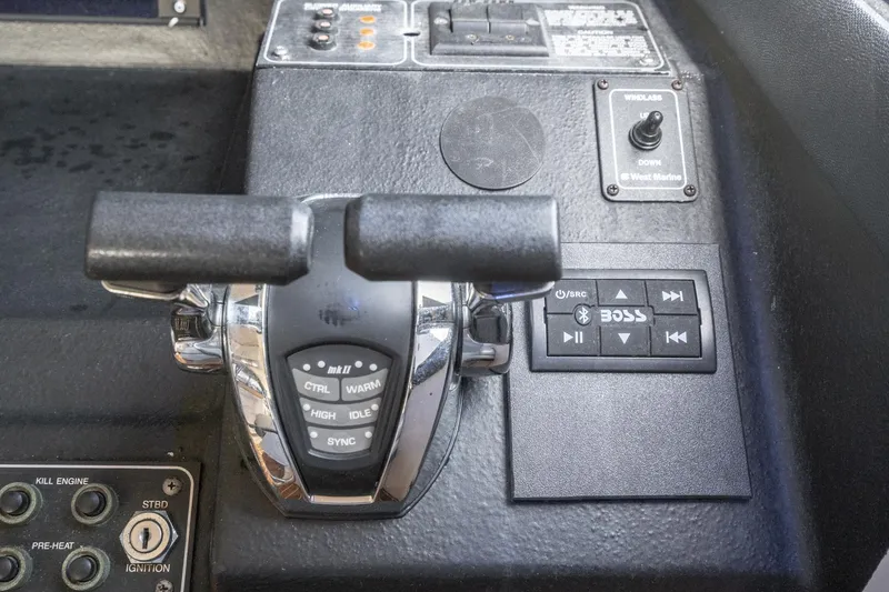 Slide: The Image of Control panel of a 1992 Bayliner 4388 boat with throttle and audio controls. - 39