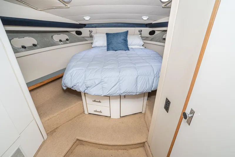 Slide: The Image of Cozy bedroom in 1992 Bayliner 4388 yacht with blue bedding and storage drawers. - 41