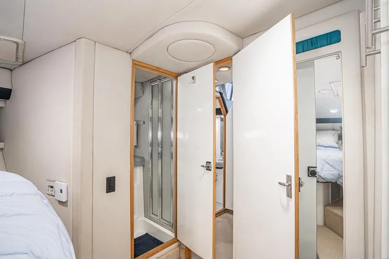 Slide: The Image of Interior of 1992 Bayliner 4388 yacht showing bathroom and bedroom with modern design. - 43