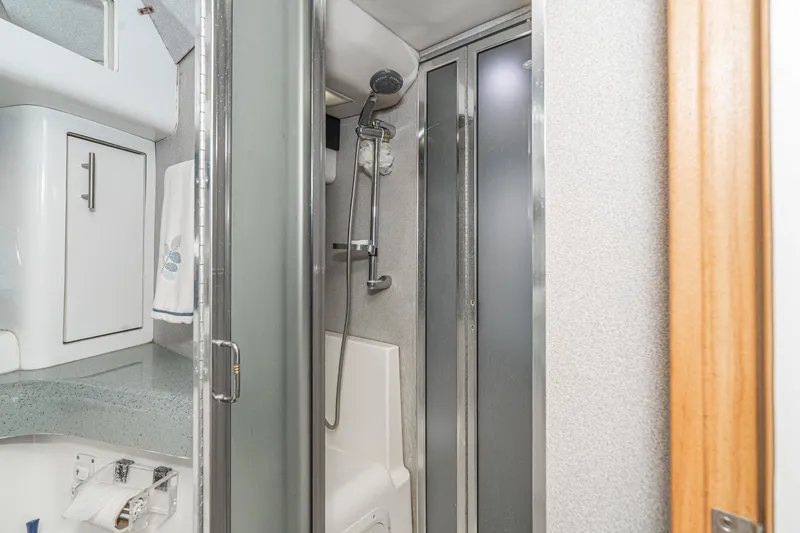 Slide: The Image of Bathroom interior of 1992 Bayliner 4388 yacht with shower and storage cabinets. - 45