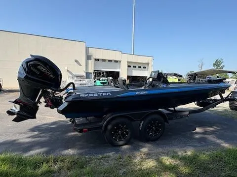 Slide: The Image of 2026 Skeeter ZXE20 boat with trailer, parked outdoors near a building. - 10