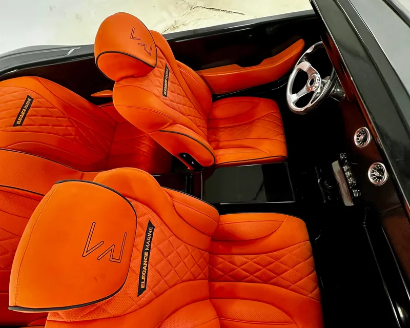 Slide: The Image of 2025 Fabbro Jet Car RR interior with vibrant orange quilted seats and sleek steering wheel. - 27