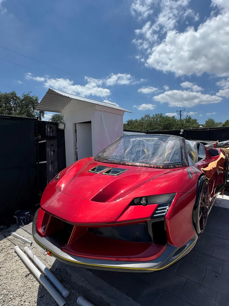 Slide: The Image of Red 2025 Fabbro Jet Car RR with sleek design under a blue sky. - 31