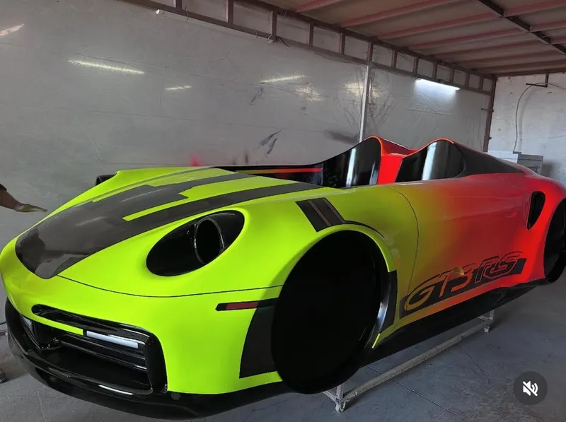 Slide: The Image of Fabbro Jet Car RR 2025 in vibrant yellow and orange gradient, displayed indoors. - 33