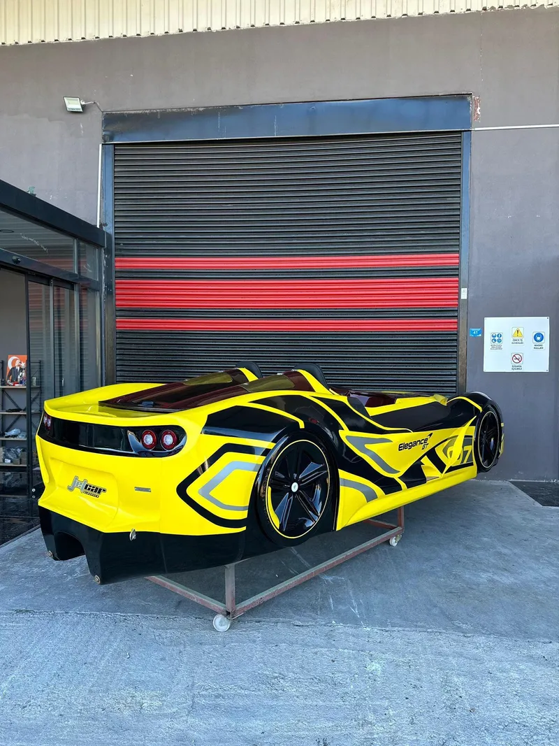 Slide: The Image of Yellow and black 2025 Fabbro Jet Car RR parked outside a garage. - 38