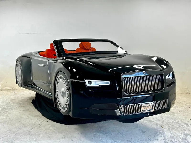 Slide: The Image of 2025 Fabbro Jet Car RR, black convertible with red interior, in a showroom setting. - 6