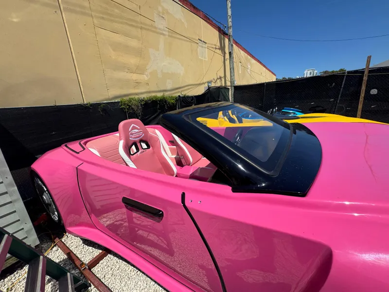 Slide: The Image of Pink 2025 Fabbro Jet Car RR convertible with sleek design, parked outdoors. - 8