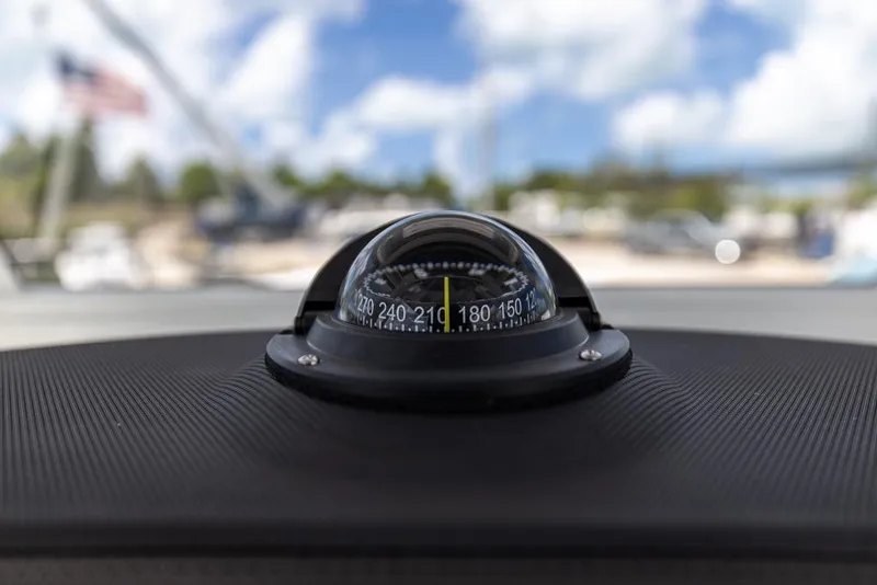 Slide: The Image of Compass on Sea Fox 288 Commander boat dashboard, 2026 model, with blurred outdoor background. - 18