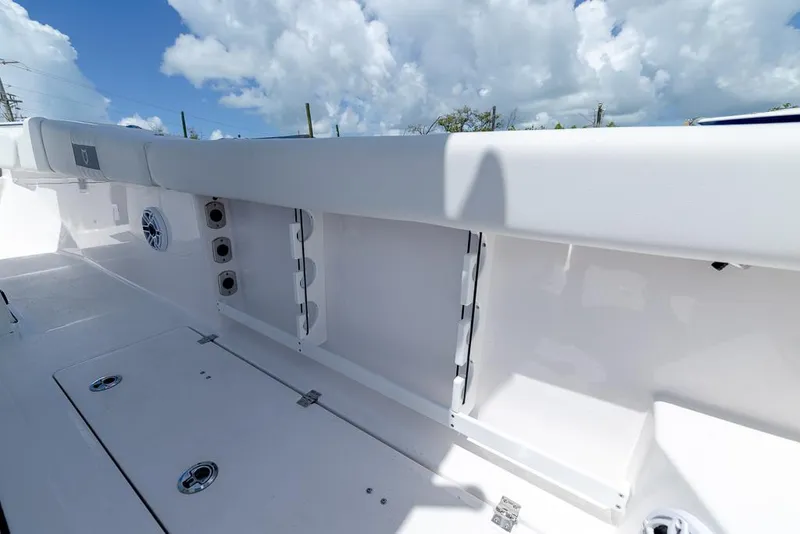 Slide: The Image of 2026 Sea Fox 288 Commander boat interior with storage compartments and speakers under a blue sky. - 24
