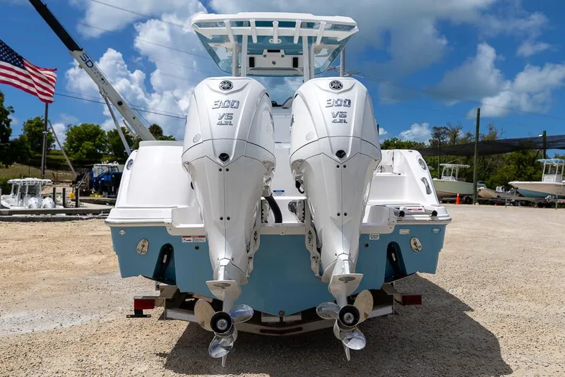 Slide: The Image of 2026 Sea Fox 288 Commander with twin 300 V6 engines, parked outdoors under a blue sky. - 3