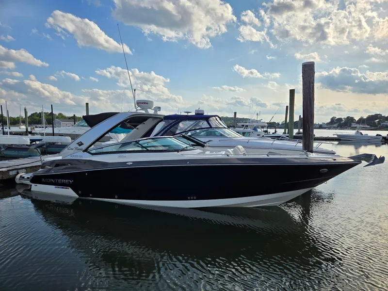 The Image of 2014 Monterey 328 Super Sport boat docked at marina under cloudy sky. - 0