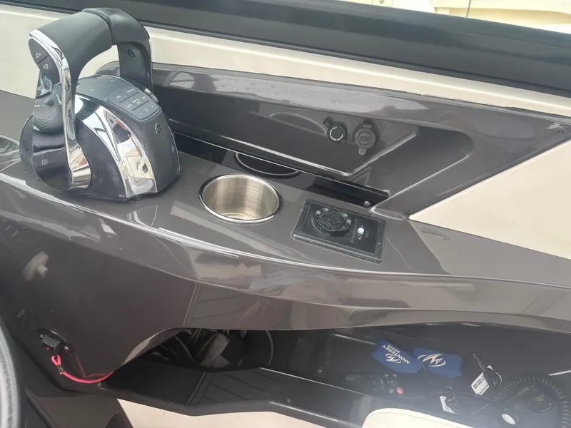 Slide: The Image of Control panel of a 2014 Monterey 328 Super Sport boat with throttle and cup holder. - 15