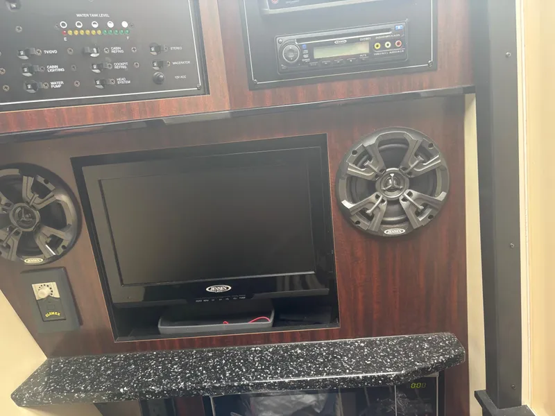 Slide: The Image of Control panel and entertainment system in a 2014 Monterey 328 Super Sport boat. - 16