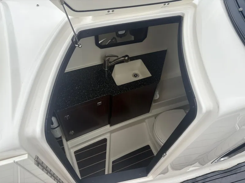 Slide: The Image of Interior of 2014 Monterey 328 Super Sport boat with sink and storage cabinets. - 19