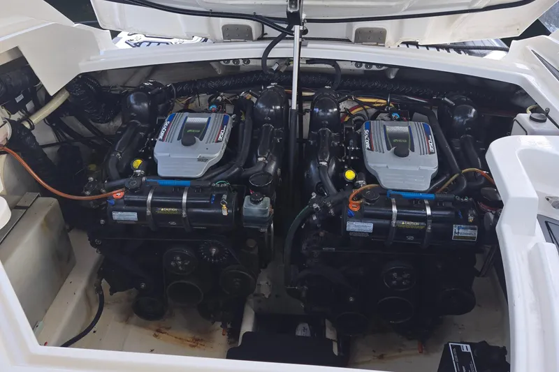 Slide: The Image of Engine compartment of a 2014 Monterey 328 Super Sport boat, featuring dual engines. - 2