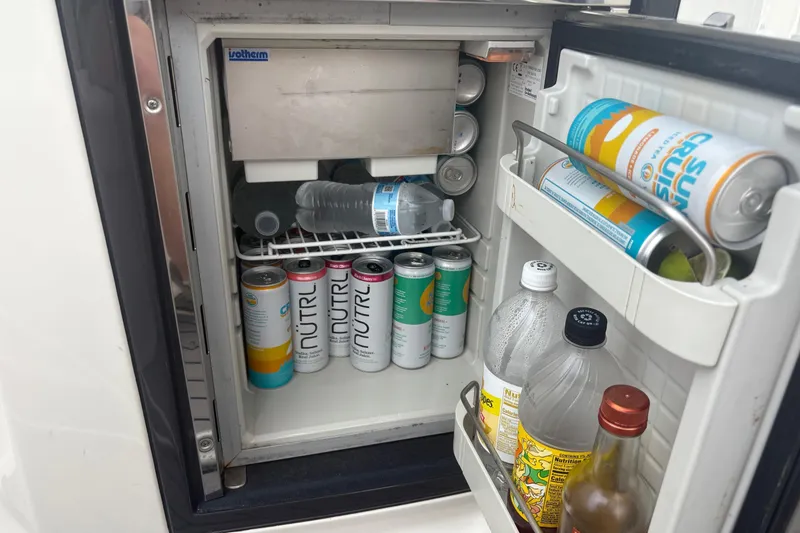 Slide: The Image of Mini fridge stocked with assorted beverages on a 2014 Monterey 328 Super Sport boat. - 20