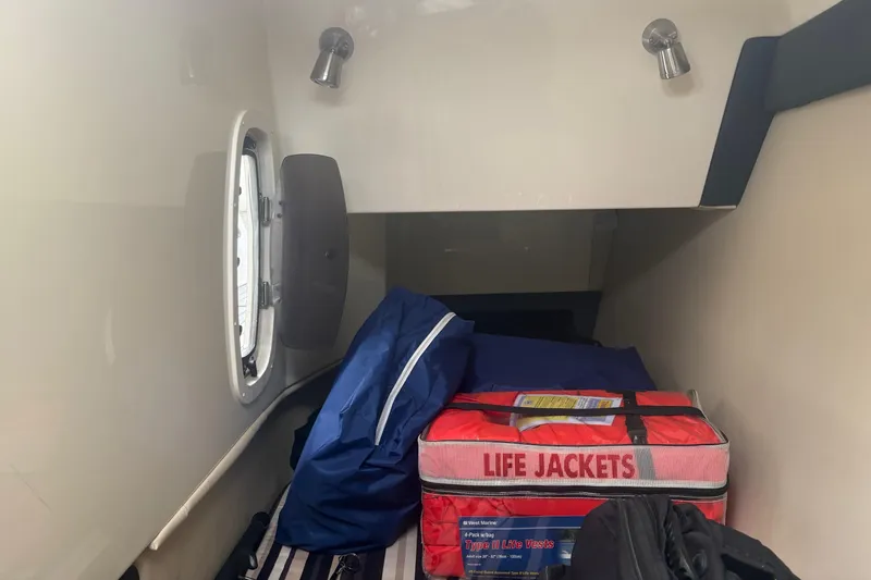 Slide: The Image of Interior cabin of 2014 Monterey 328 Super Sport with life jackets and storage. - 21